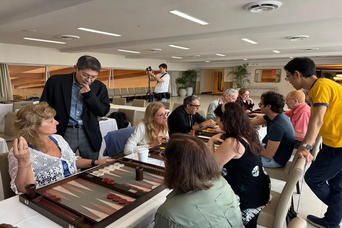 Players around a backgammon board